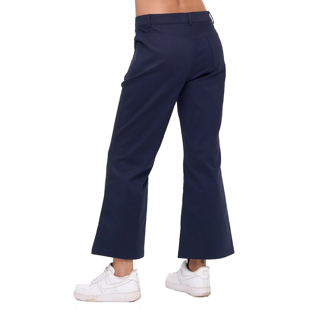 Rear view of a person wearing navy blue Valentina wide-leg ankle pants and white sneakers.