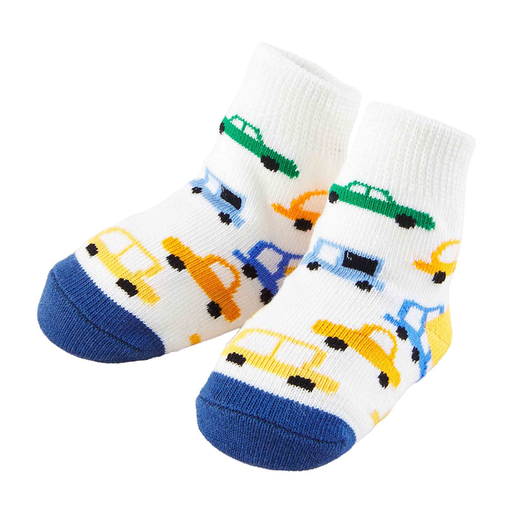 White baby socks with a blue toe and heel, featuring a colorful print of small green, yellow, and blue cars.