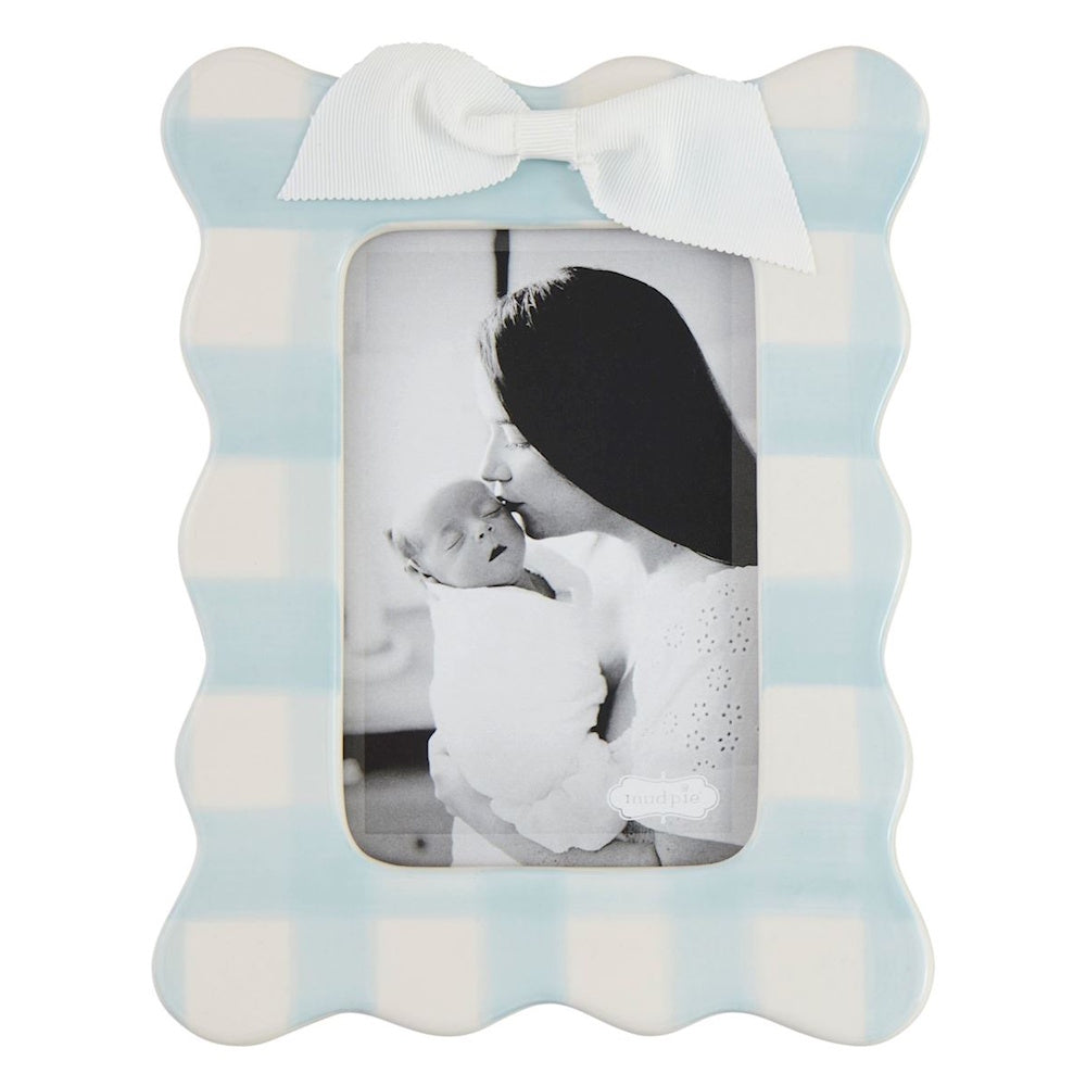 Blue and white gingham scalloped picture frame with white bow and black and white photo of mother and baby.