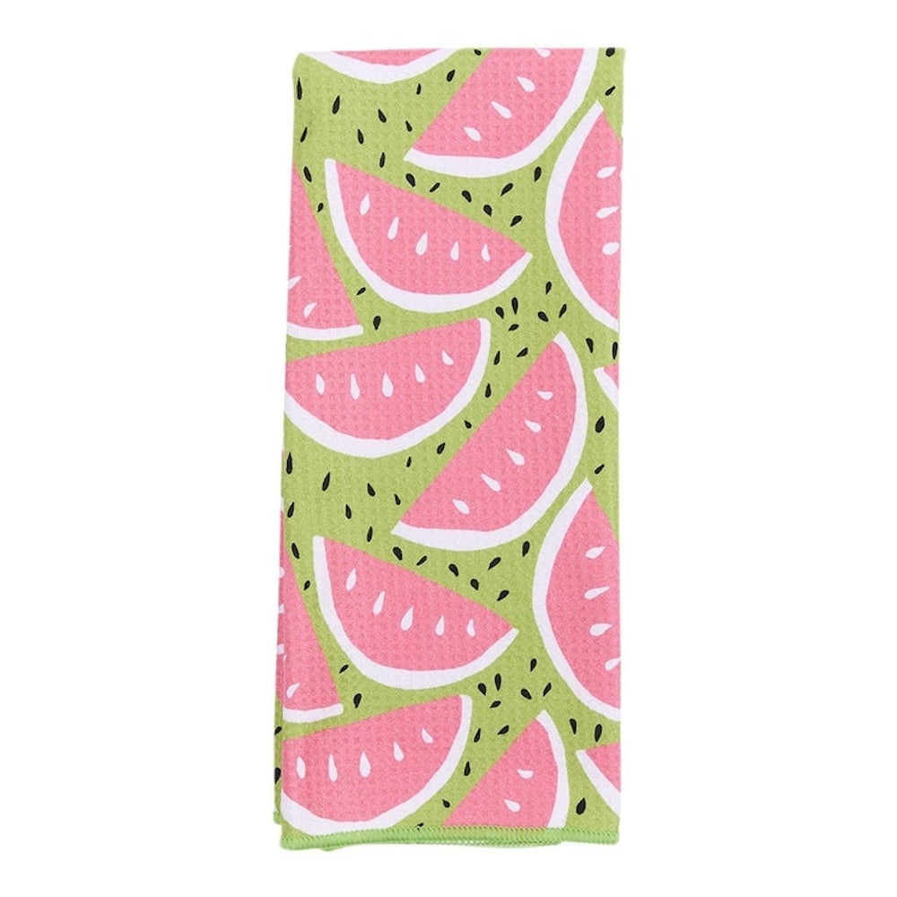 A folded green kitchen towel featuring a pattern of pink watermelon slices and small black seeds.