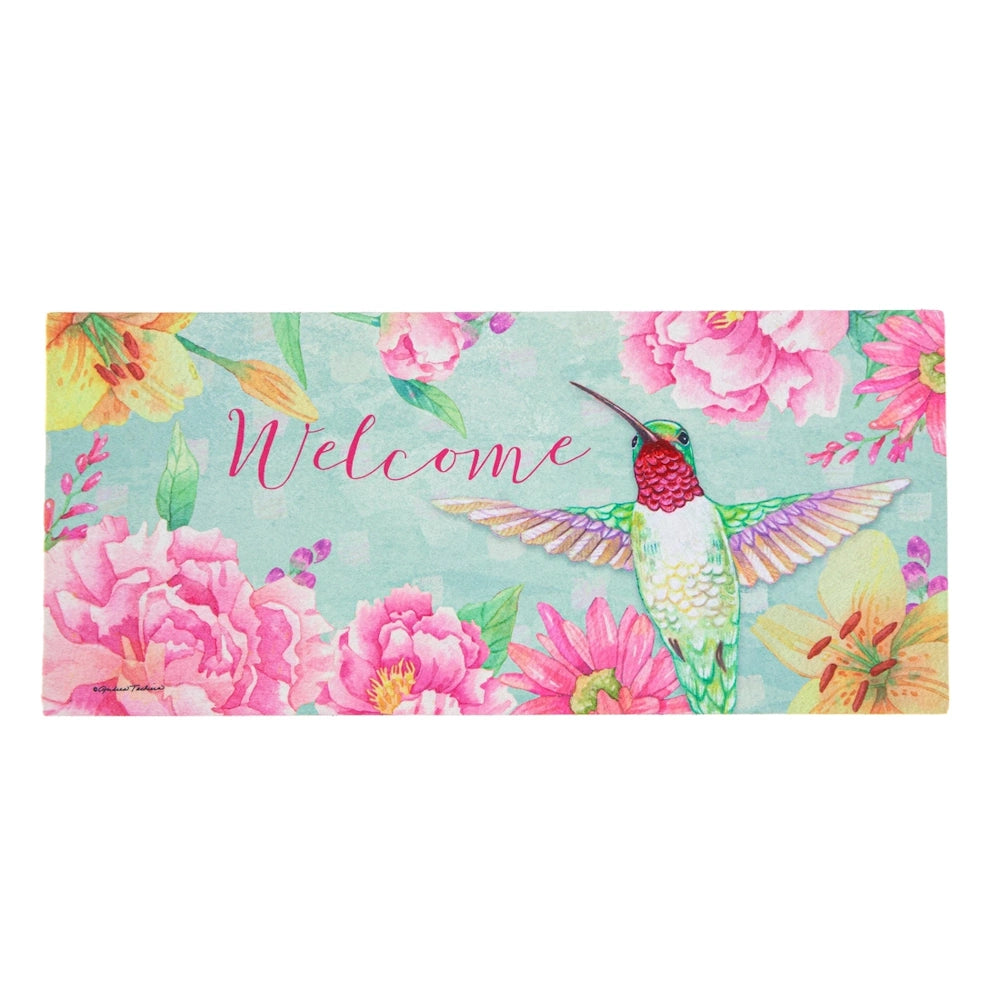 A watercolor doormat reading 'Welcome', with a hummingbird surrounded by pink and yellow flowers on a teal background.