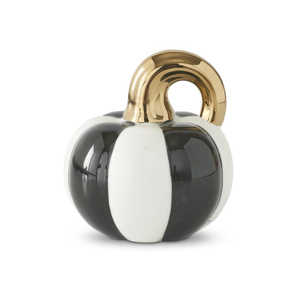 Glossy black and white striped ceramic pumpkin tabletop decor featuring a shiny metallic gold stem.