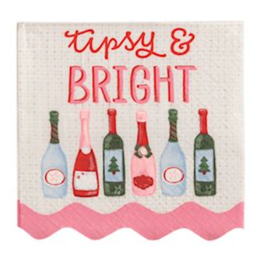 White napkin reading "Tipsy & Bright" above a line of colorful holiday wine and champagne bottles.