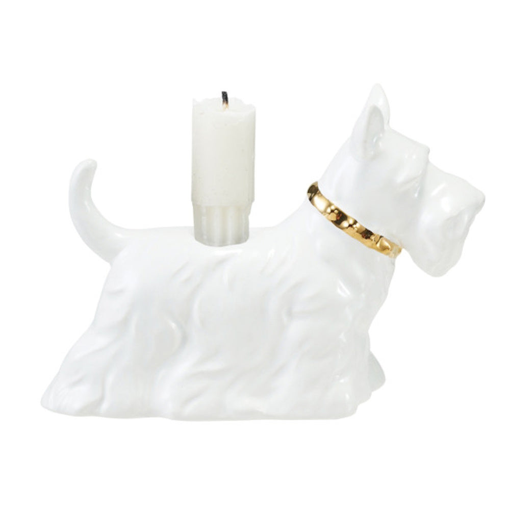 White ceramic Scottie dog taper candle holder with a gold collar and white candle against a plain background.
