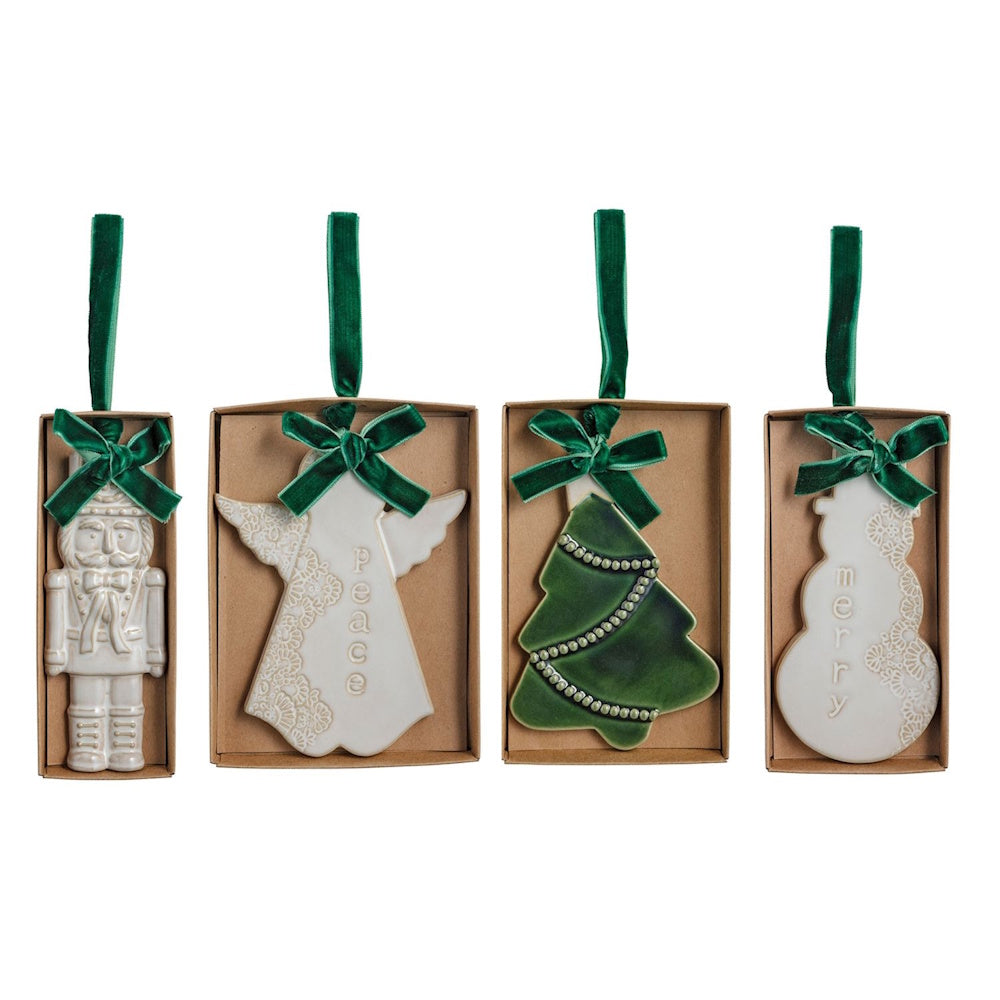 Four ceramic Christmas ornaments: nutcracker, angel, tree, and snowman with green ribbons.