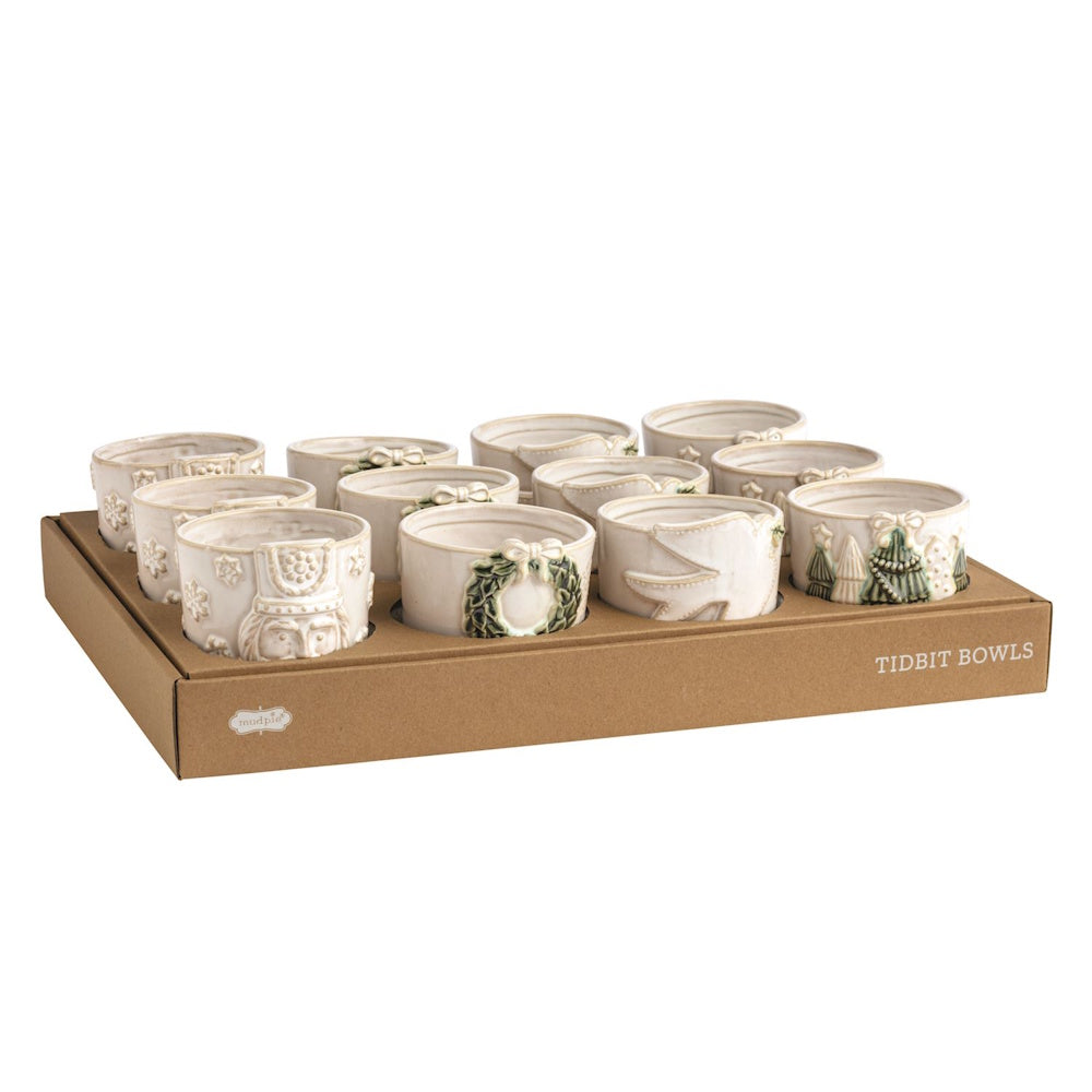 White ceramic tidbit bowls with embossed holiday designs in a display box.