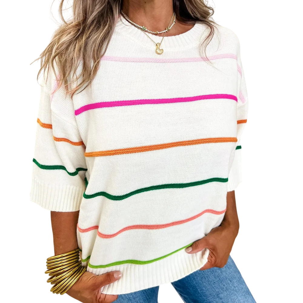 Woman wears a white crewneck knit sweater with multi-colored horizontal stripes and half-length drop sleeves.