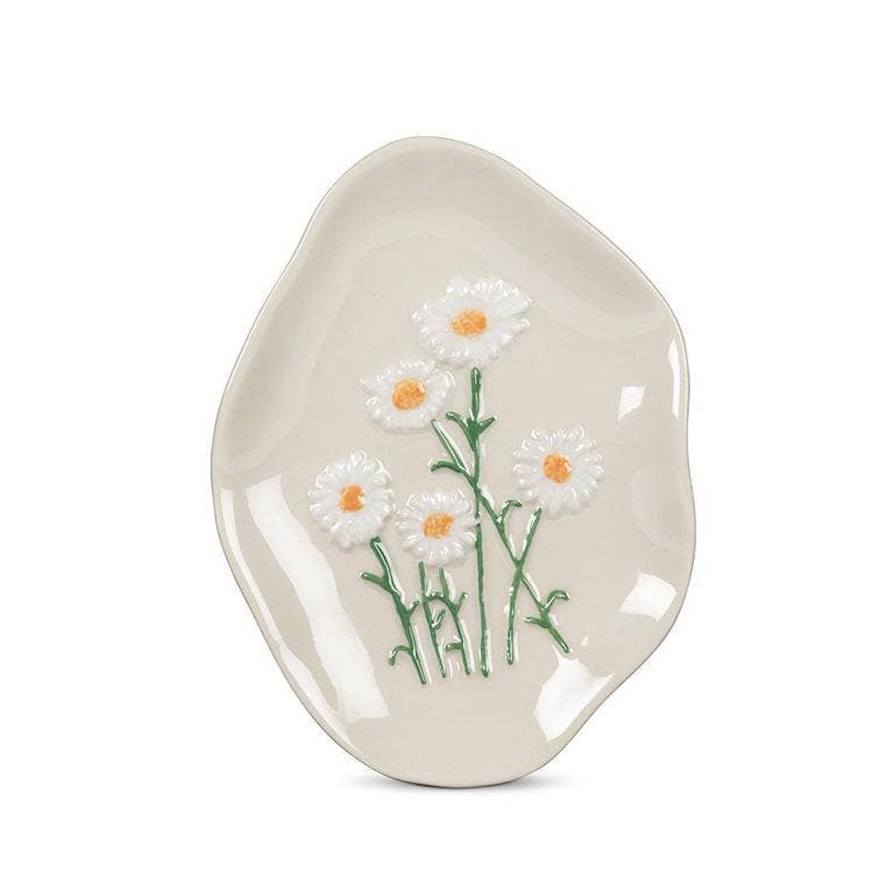 Off-white ceramic dish with an organic shape, featuring raised white daisy flowers on green stems.