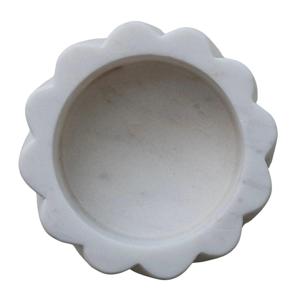 Top-down view of a white marble scalloped bottle holder with a carved flower-like edge and natural grey veining.