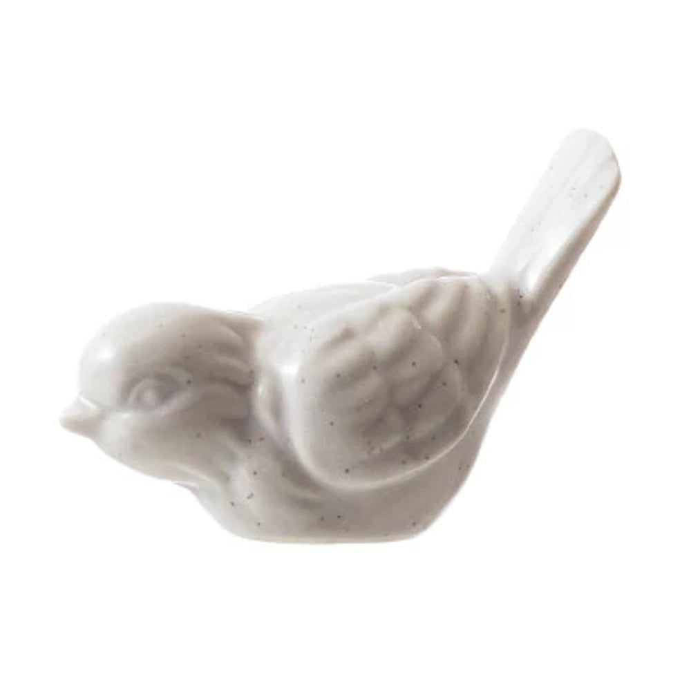 Speckled white matte stoneware bird figurine with textured wings, isolated on a white background.