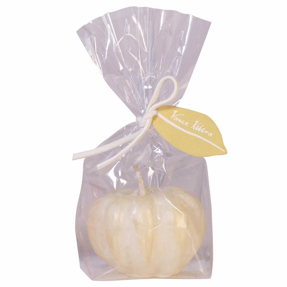 White pumpkin candle wrapped in clear cellophane with a white ribbon tied to a yellow leaf-shaped tag.