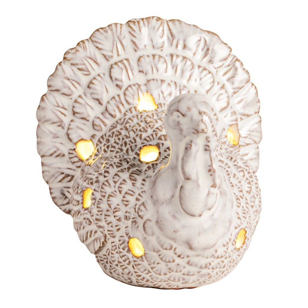 White ceramic light-up turkey figurine with glowing cutout details.