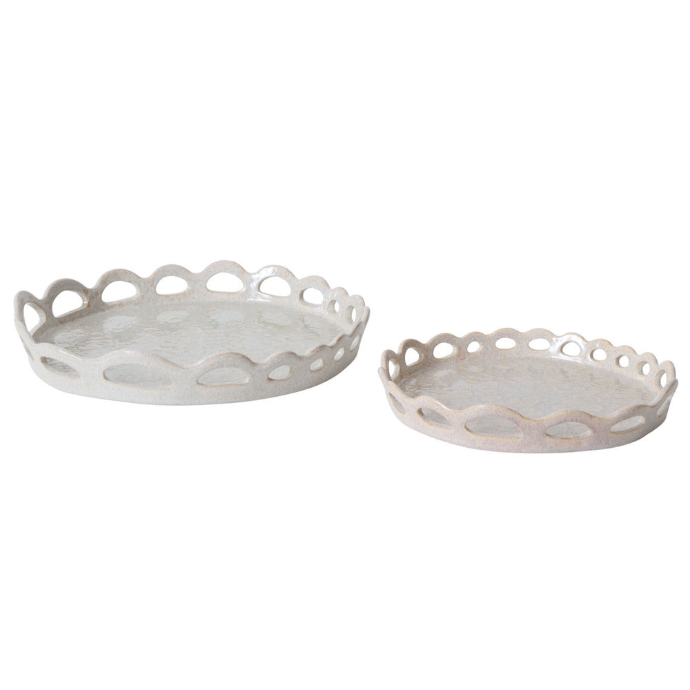 Two round, ceramic decorative trays with a scalloped, cutout rim and a glossy, textured light gray glaze.