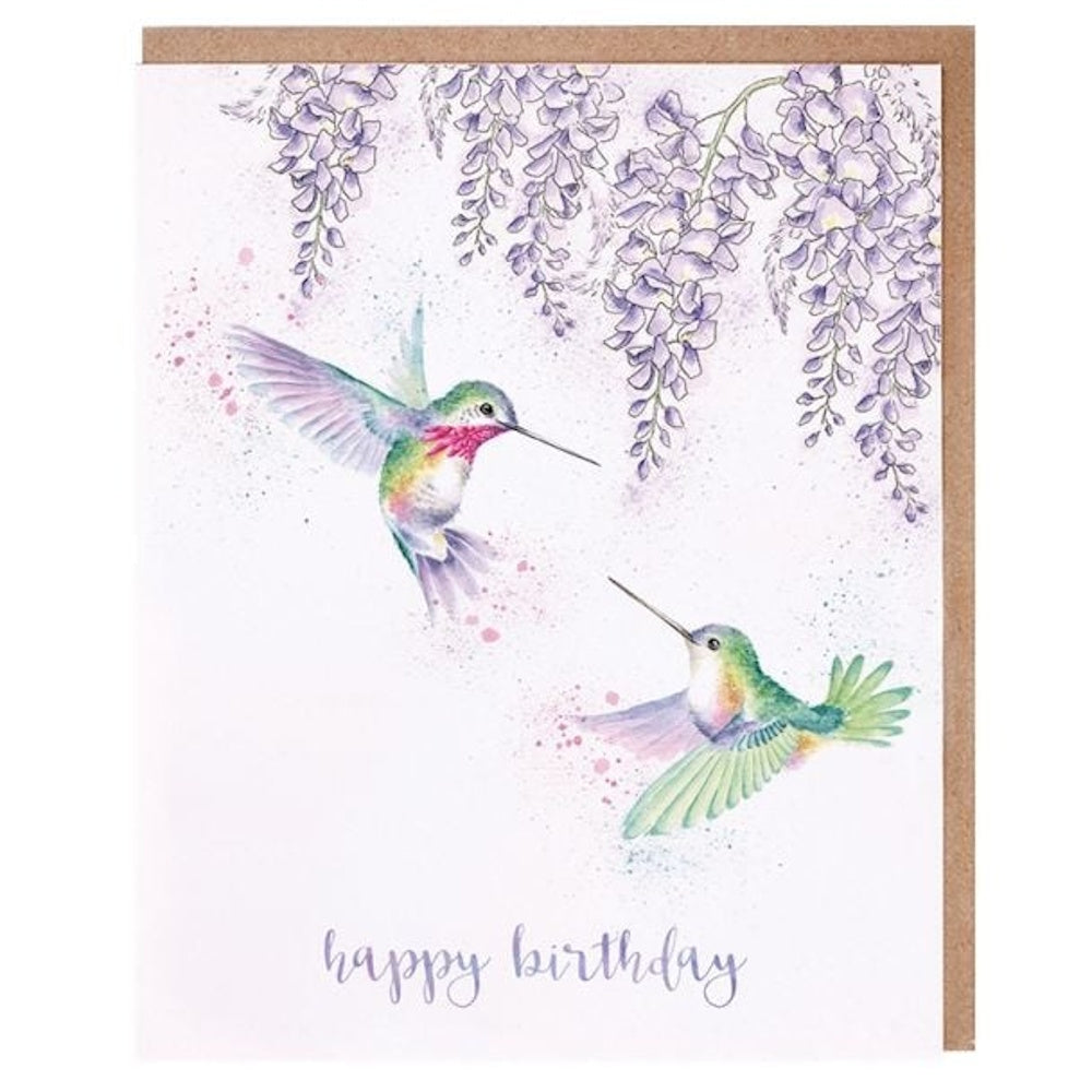 Watercolor hummingbirds flying near purple wisteria flowers on a "Happy Birthday" greeting card with a kraft envelope.