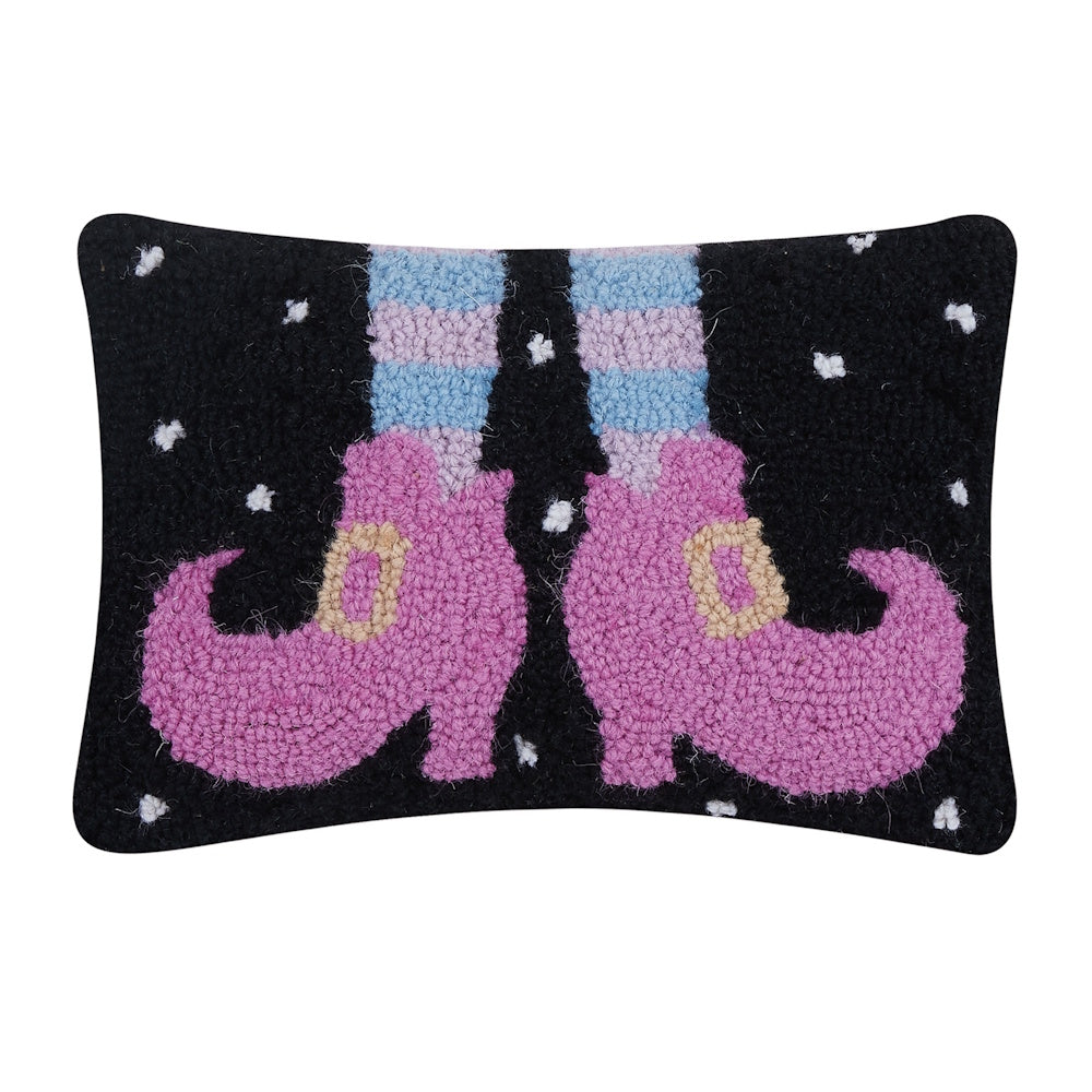 Black hooked throw pillow featuring pink witch shoes with striped stockings and a starry background.
