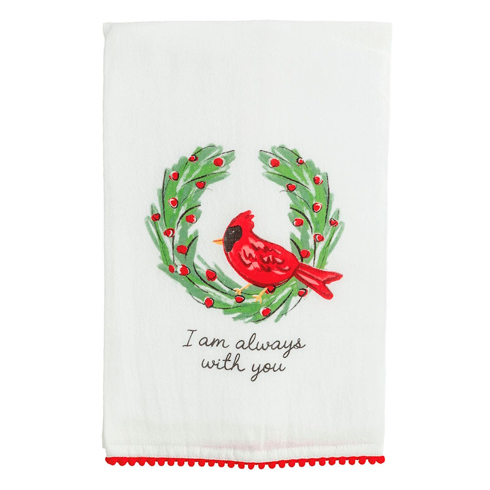 Red cardinal inside a berry wreath on a towel reading "I am always with you" with pom-pom trim.