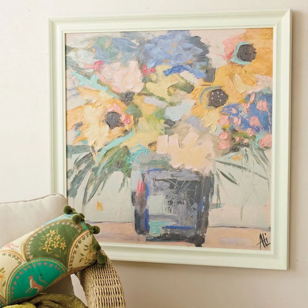 Framed canvas wall decor featuring an abstract impasto oil painting of yellow and blue flowers in a dark vase.