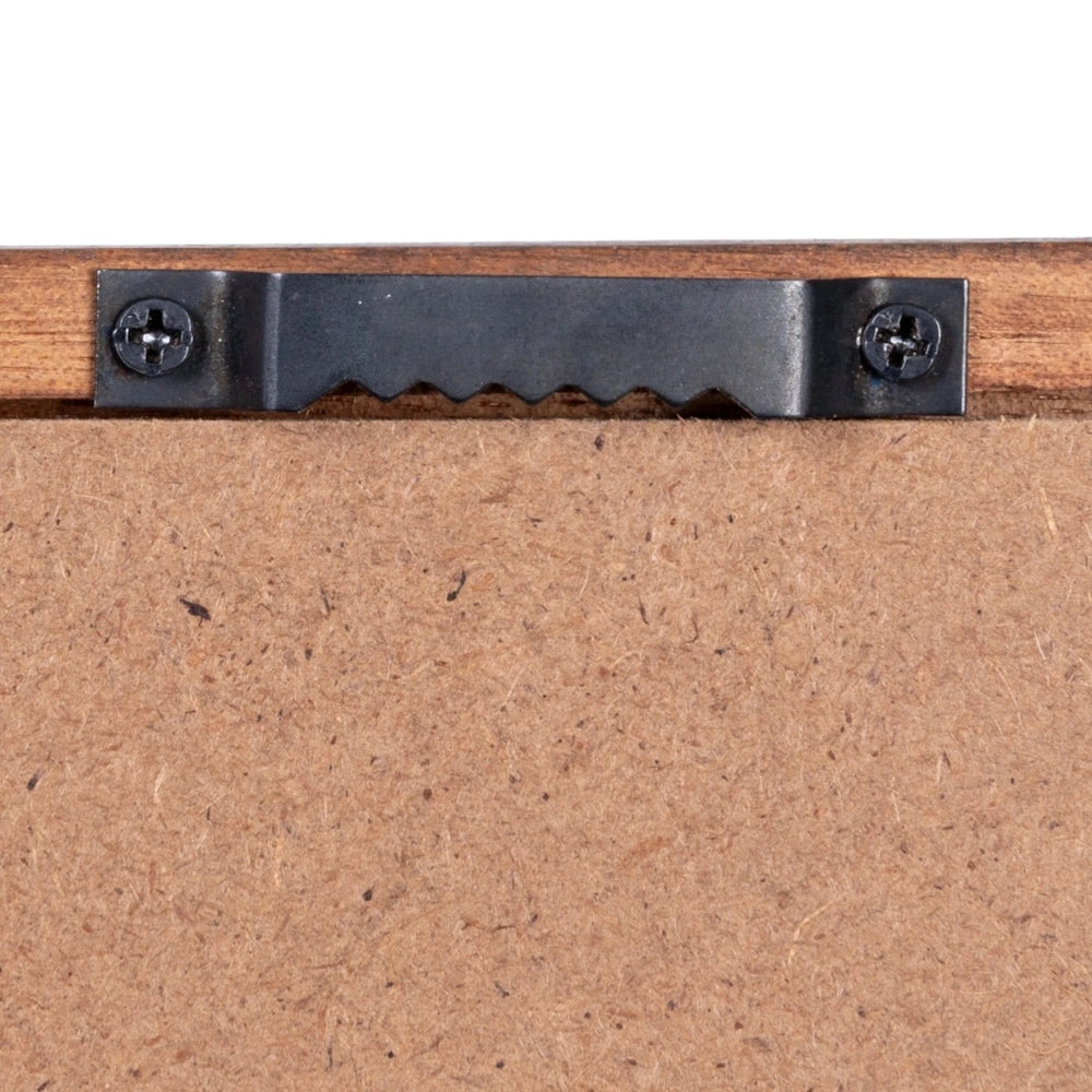 Close-up view of a black metal sawtooth hanger secured with two screws on the back of a wooden frame.