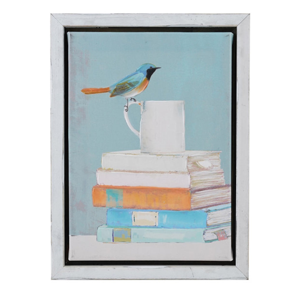 Hand-painted canvas wall decor featuring a blue bird perched on a white mug atop a stack of books in a white wood frame.