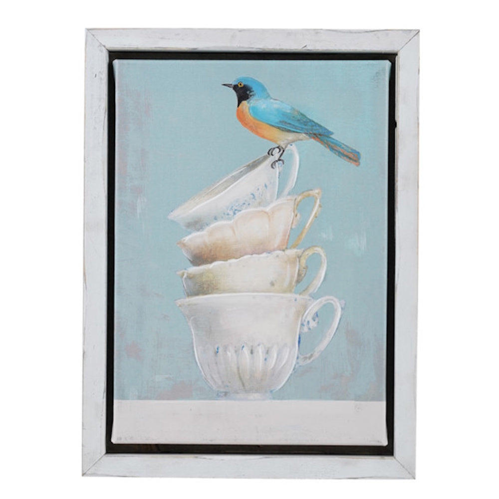 Framed canvas wall art of a blue bird perched on a stack of vintage teacups with a light blue background.