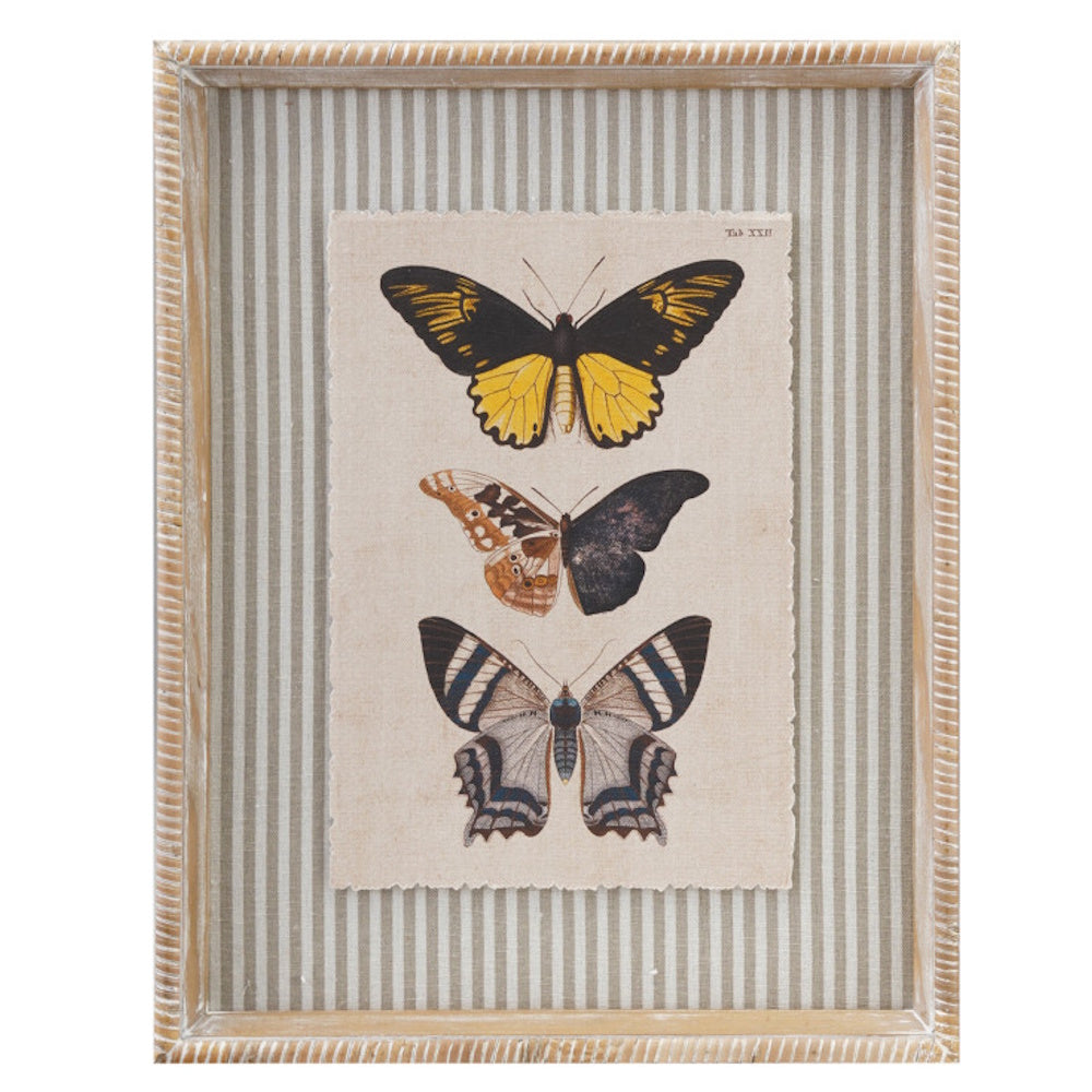 Wood-framed wall decor featuring three illustrated butterflies on deckle-edged paper over a striped fabric mat.