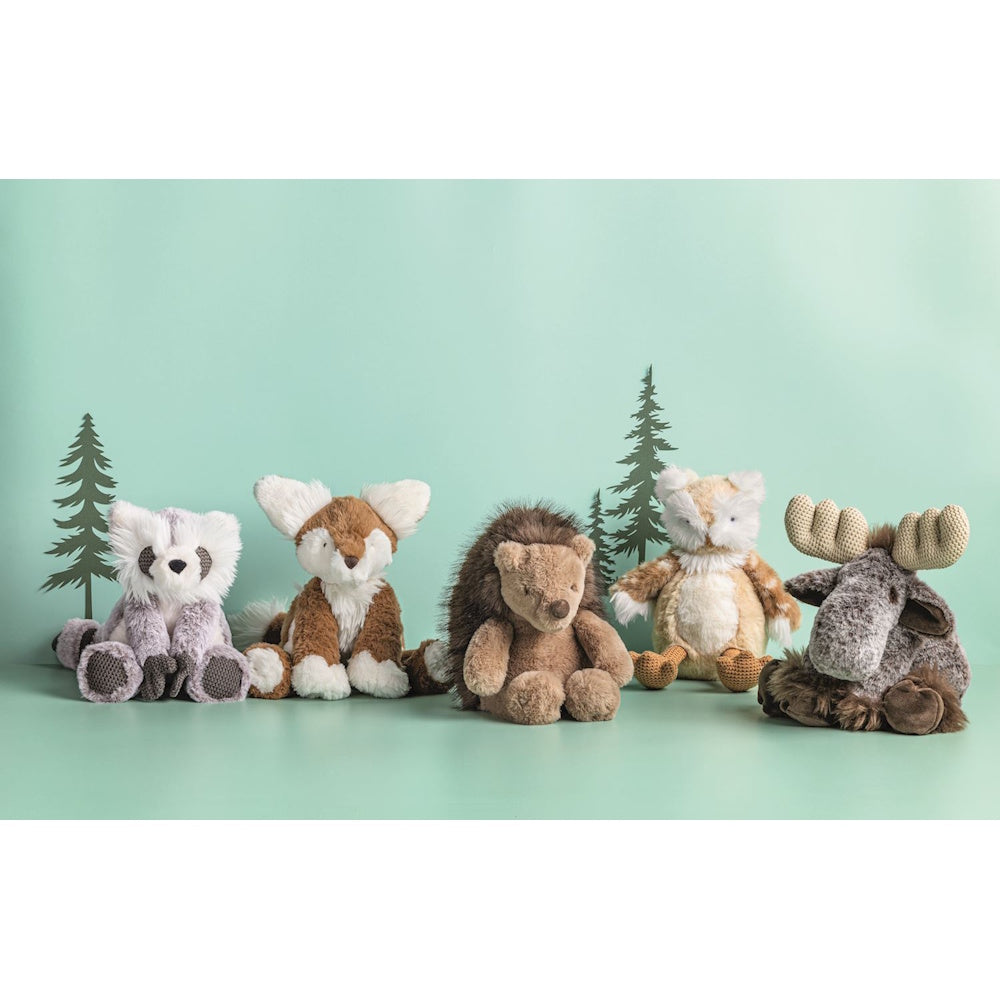 Five plush woodland animals sitting in a row against a mint green background.