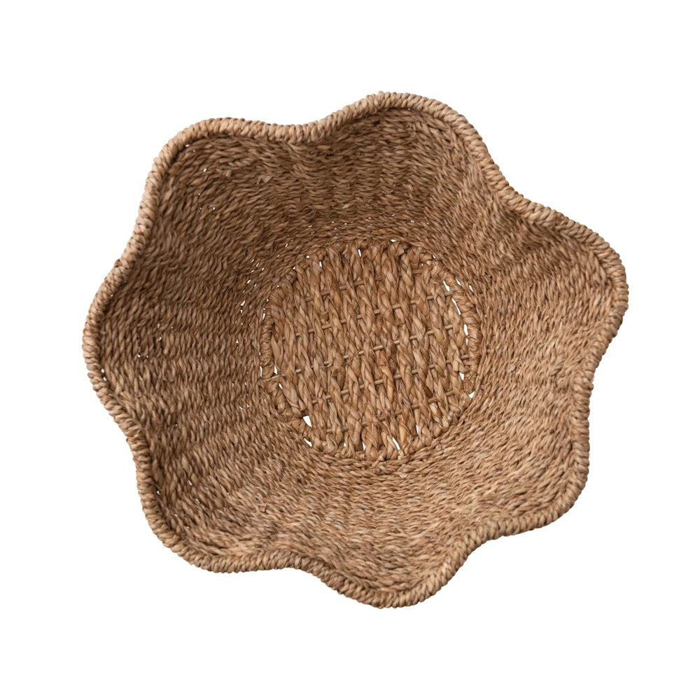 Top view of a brown woven rattan ruffled bowl with a round base design.