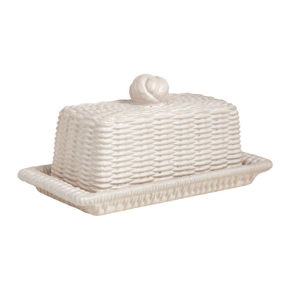 Woven white ceramic butter dish with lid and decorative knot handle, farmhouse style kitchenware on a white background.