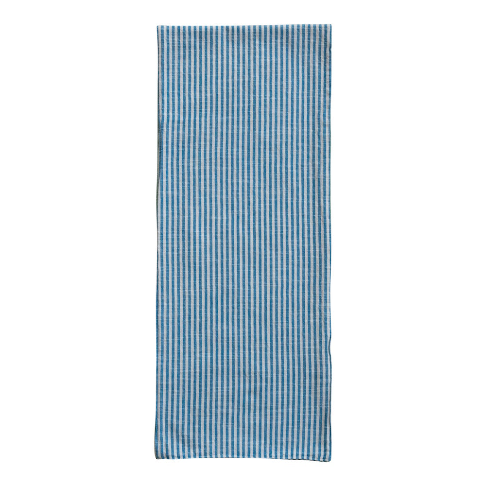 Woven cotton two-sided striped table runner styled on a wooden dining table for modern farmhouse decor.