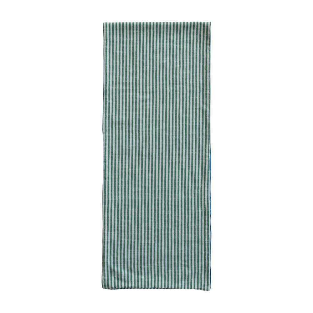 Woven cotton striped table runner in green and white for rustic dining room decor.