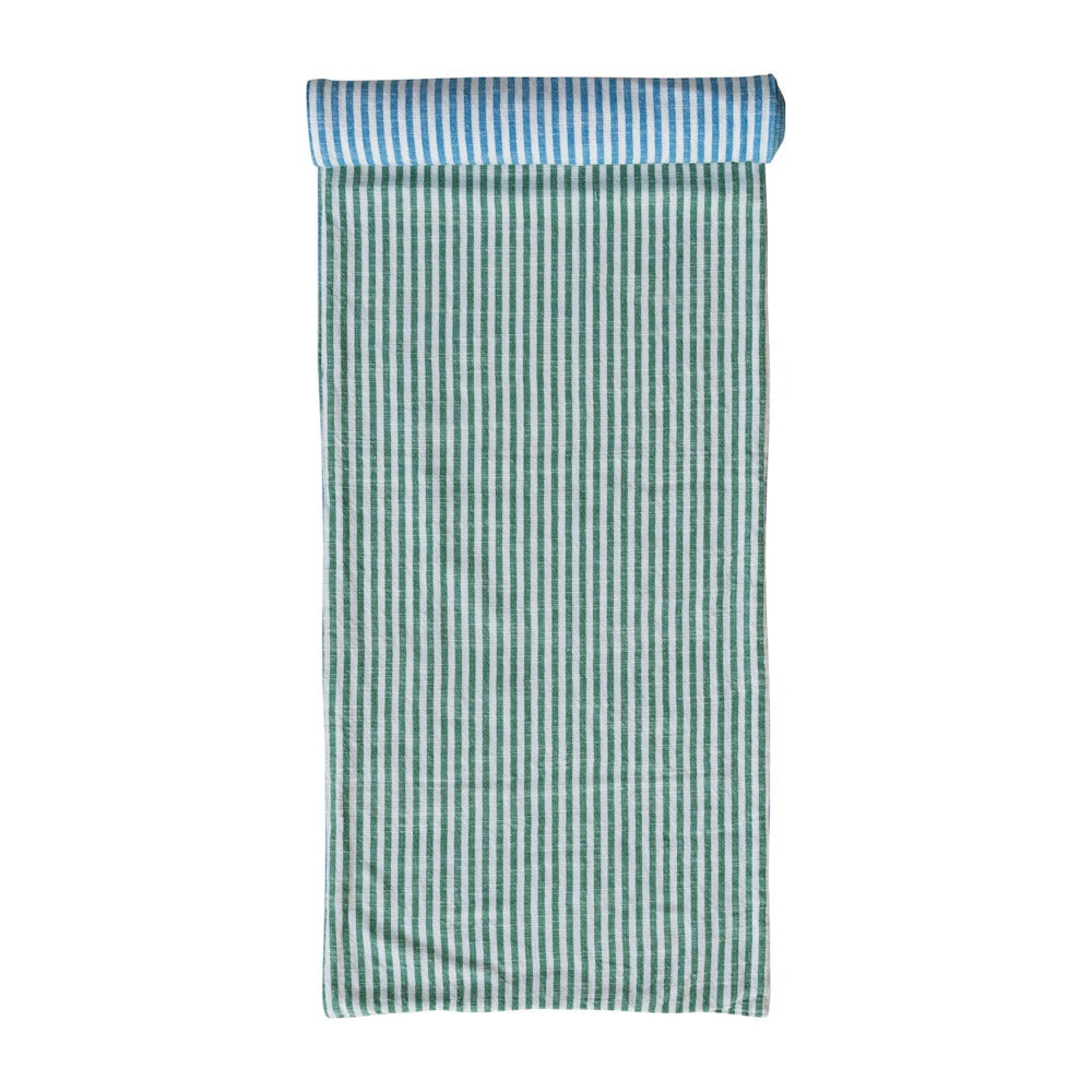 Woven cotton striped table runner featuring a reversible design with green and blue vertical stripes.