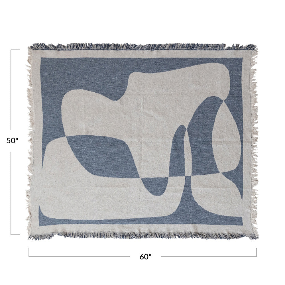 A blue and cream woven jacquard throw blanket with abstract shapes, fringed edges, and 50" by 60" dimensions.