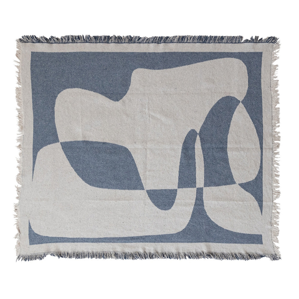 A rectangular woven throw blanket with a blue and cream abstract organic design and fringed edges.