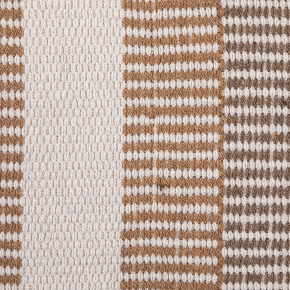 Close-up of a textured woven rug with brown and cream stripes, highlighting the detailed fabric patterns and material.