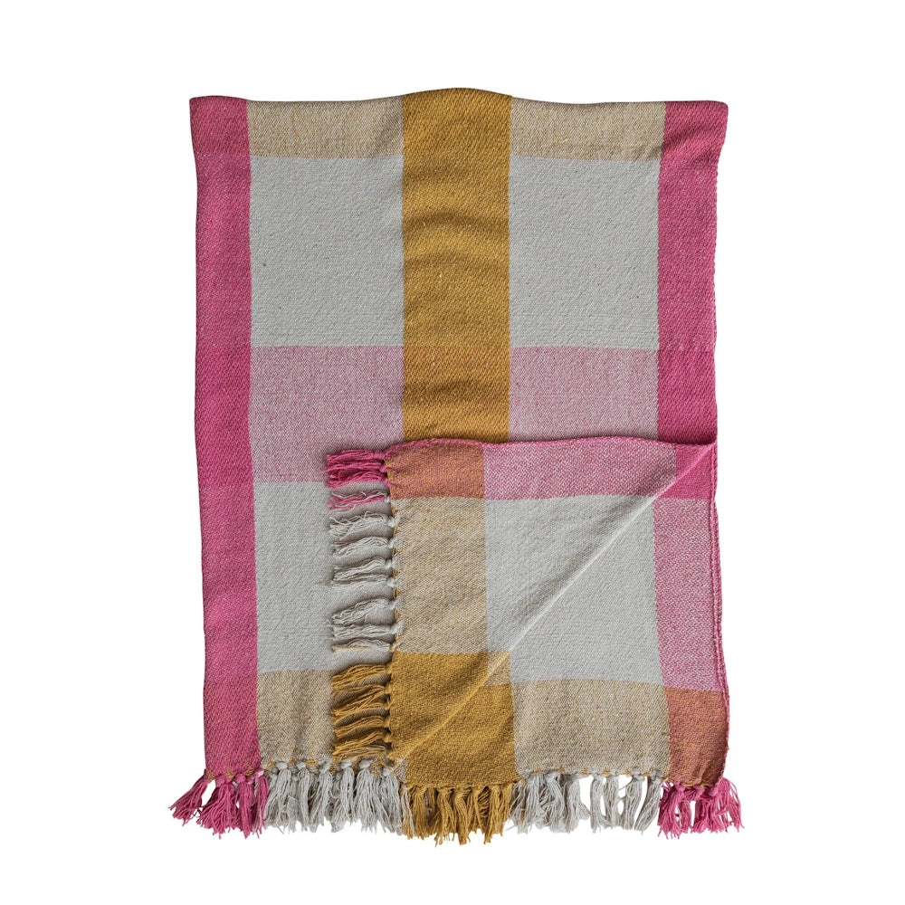 Folded pink, yellow, and cream woven check throw blanket with fringe trim.