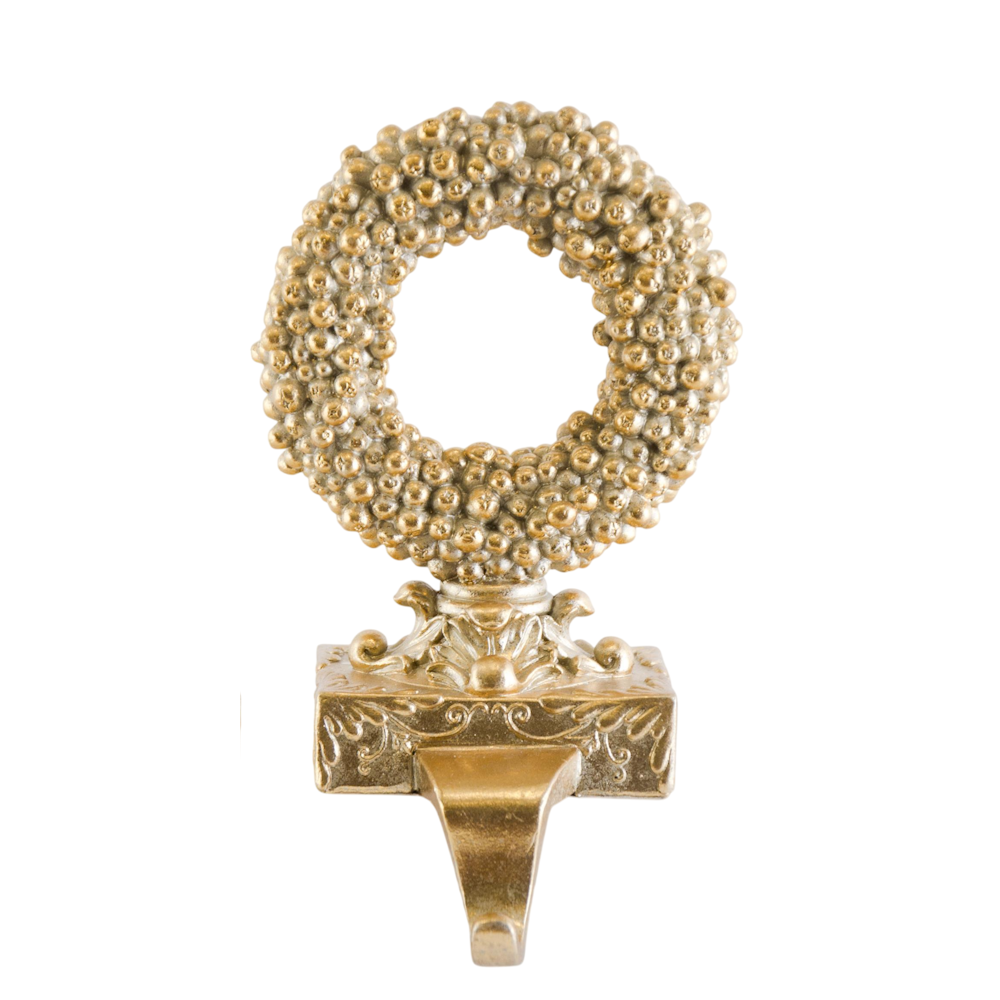 Champagne gold berry Christmas wreath stocking holder on a decorative base, set against a white background.