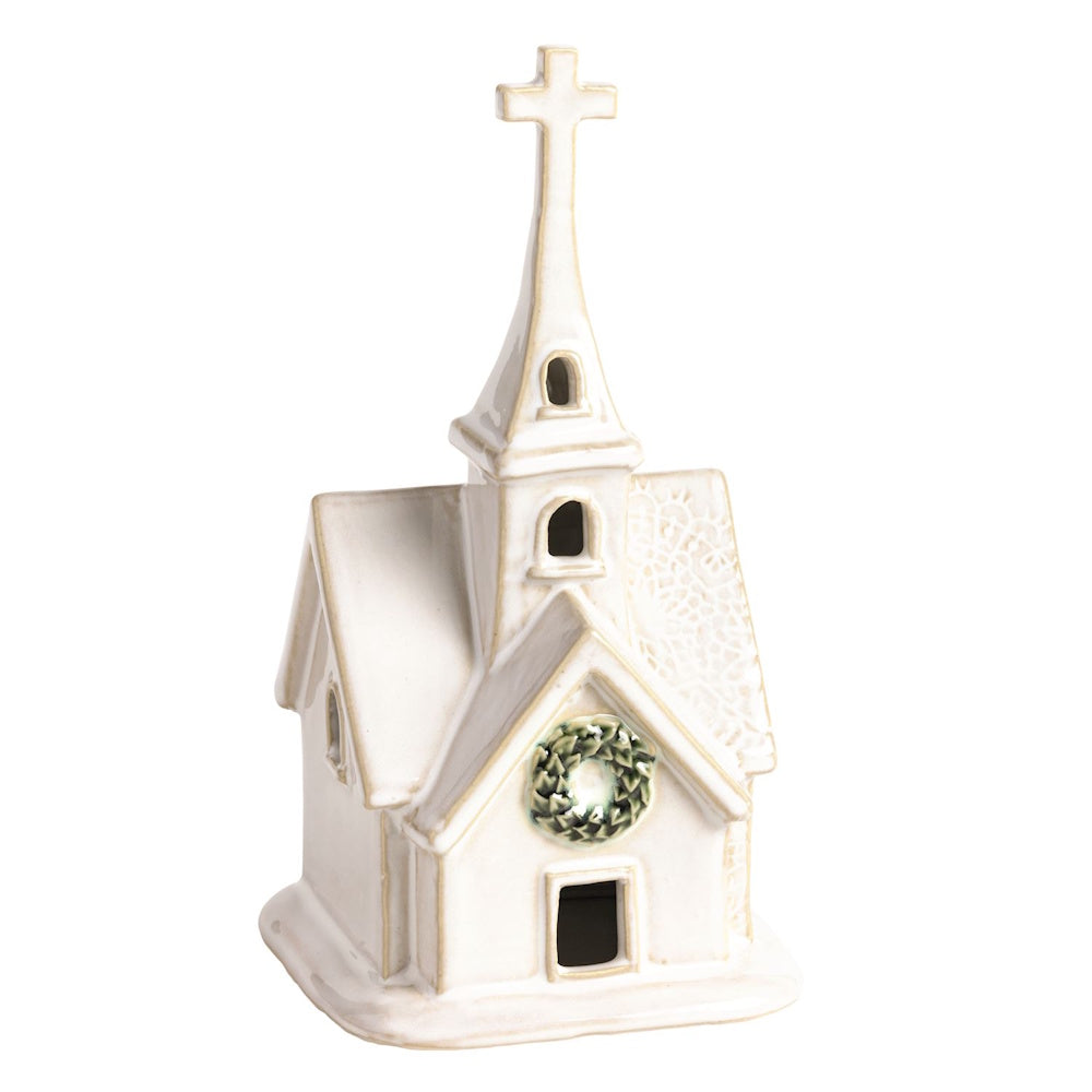 White ceramic church figurine with a cross, pressed lace roof texture, and a green wreath.