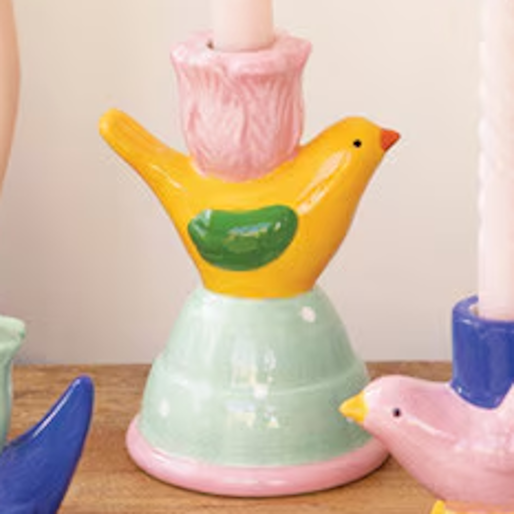 Colorful ceramic bird taper candle holder with a yellow bird, pink flower-shaped cup, and mint green polka dot base.