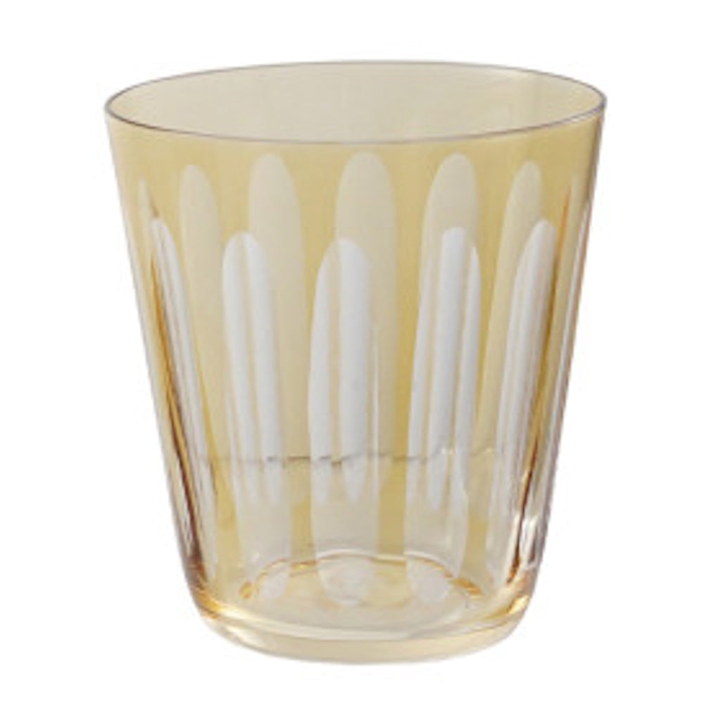 Yellow amber tumbler glass with an etched oval pattern on a white background.