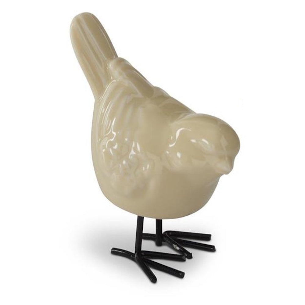 Yellow-toned cream porcelain bird figurine with a glossy finish and black metal legs on a white background.