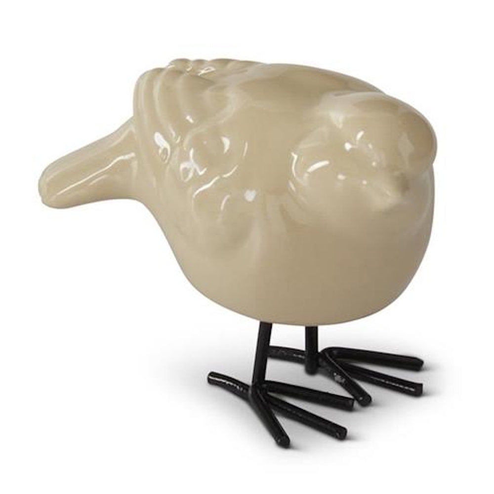 Beige porcelain bird figurine with black metal legs on a white background.