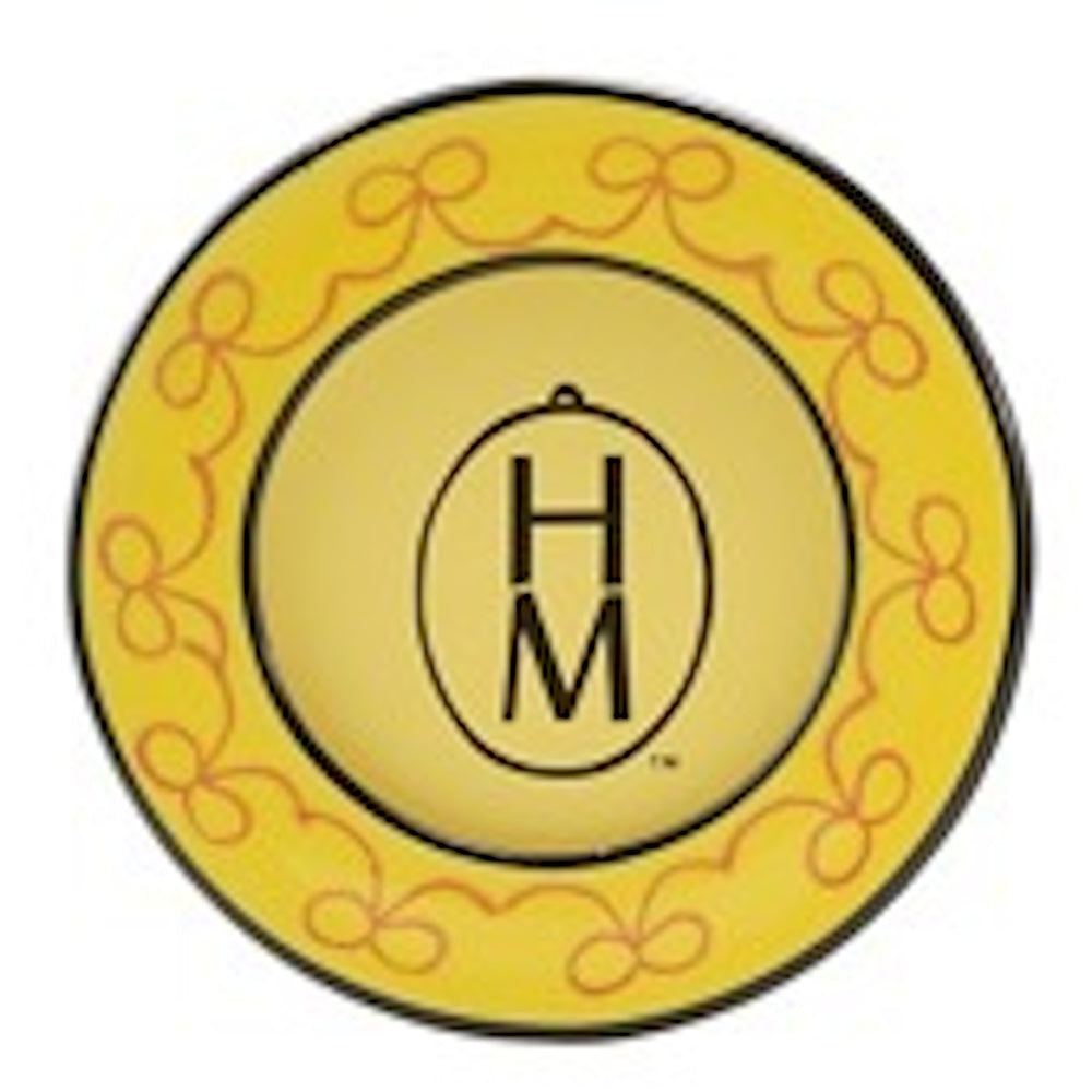 Yellow circular stoneware magnet featuring a "HM" monogram inside an oval, bordered by a delicate orange bow pattern.