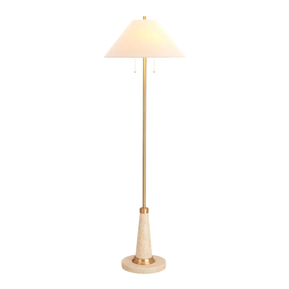 Brass floor lamp with a beige cone shade and a stone pedestal base on a plain white background.